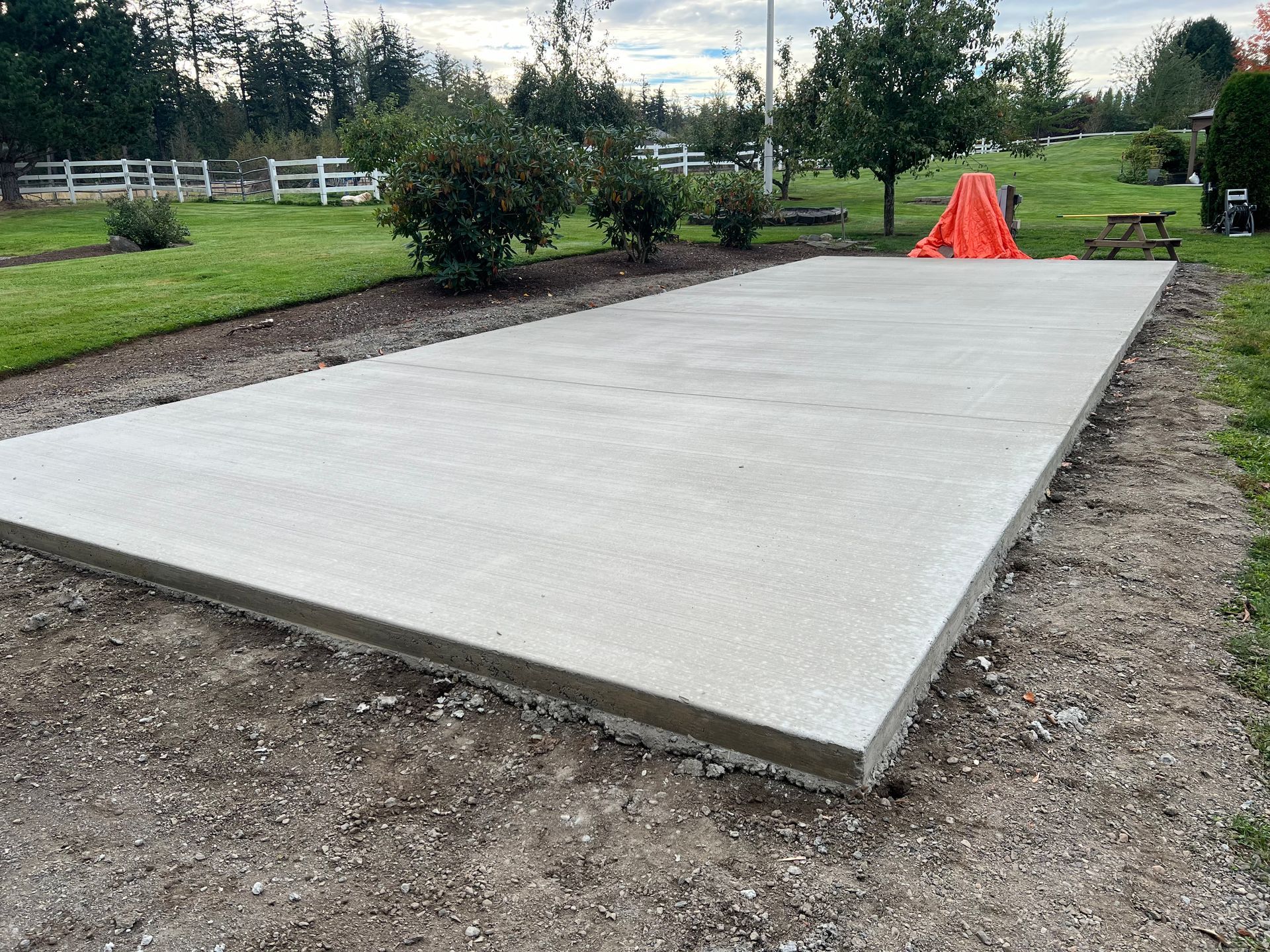 A large concrete slab is sitting on top of a dirt road.