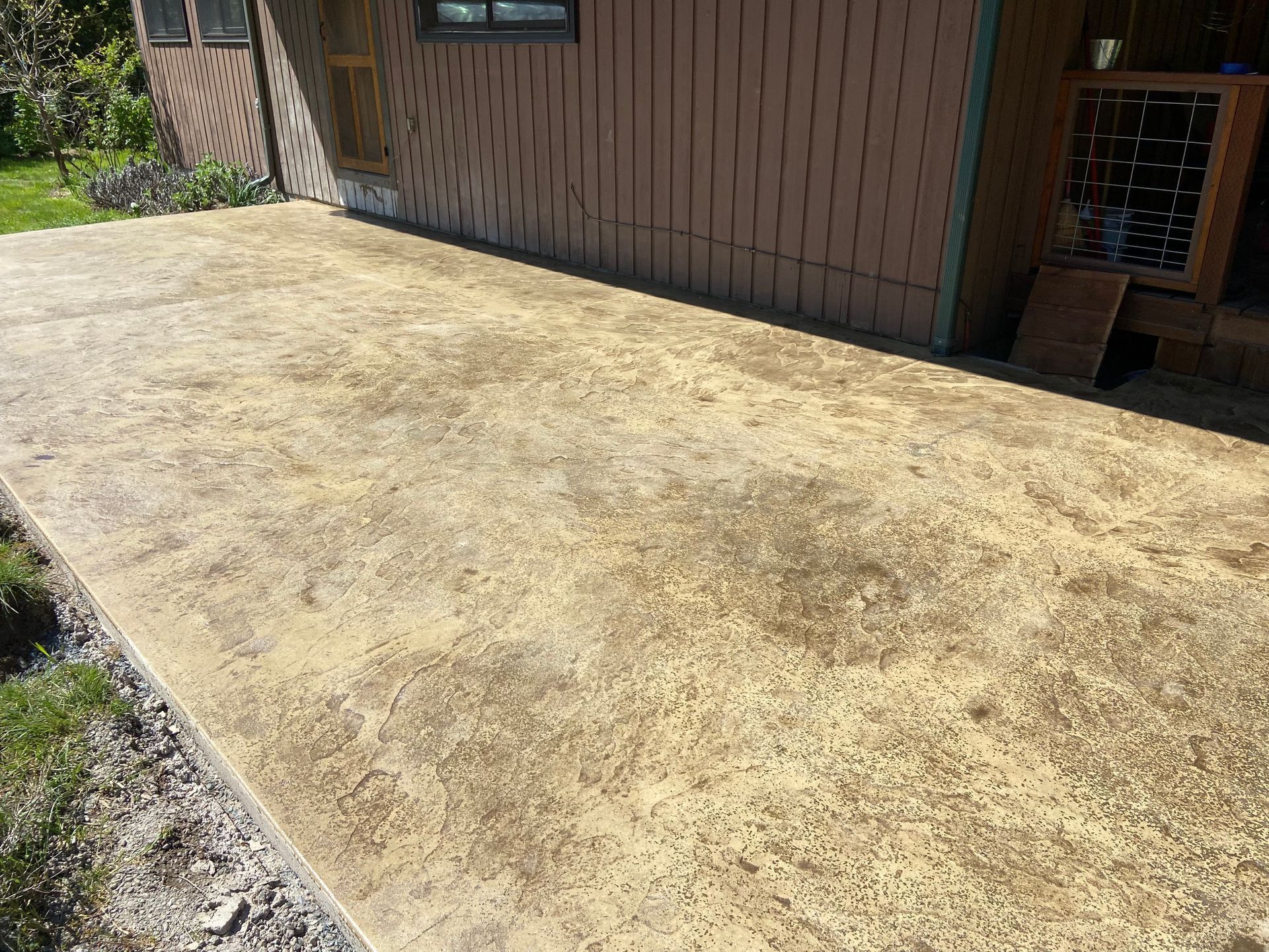 A concrete walkway is being built in front of a house.