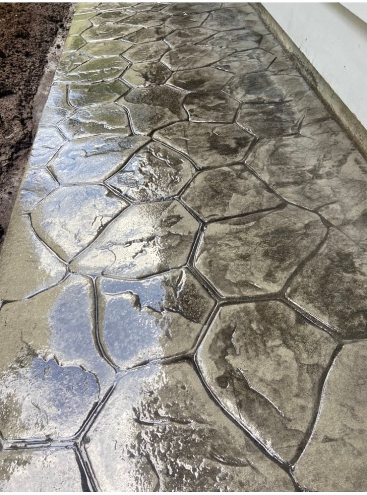 A concrete walkway that looks like a stone walkway.
