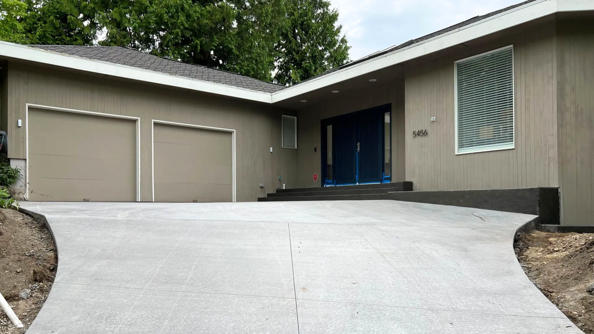 Concrete driveway with a clean broom finish installed for a home in Bellingham WA.