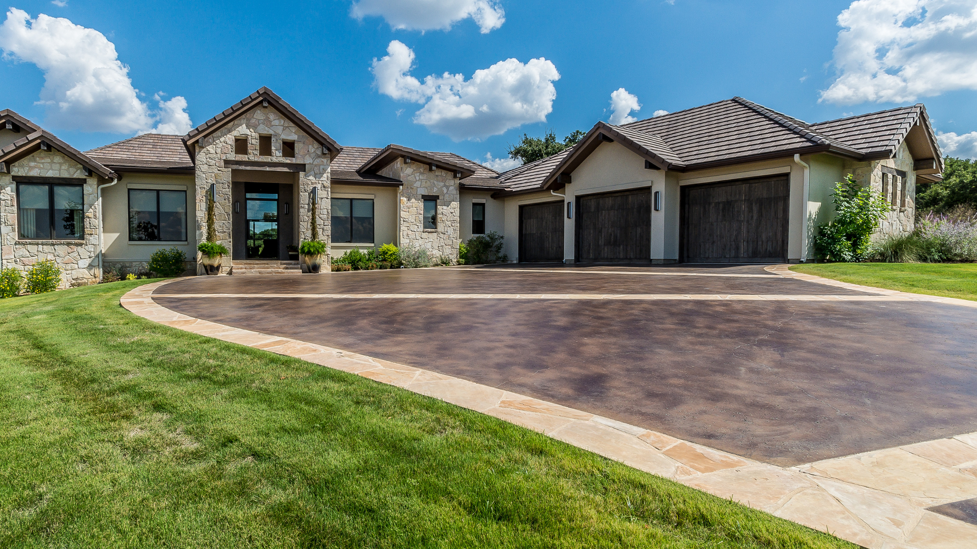 Stamped concrete driveway with stone pattern design installed at a residential home in Bellingham WA.