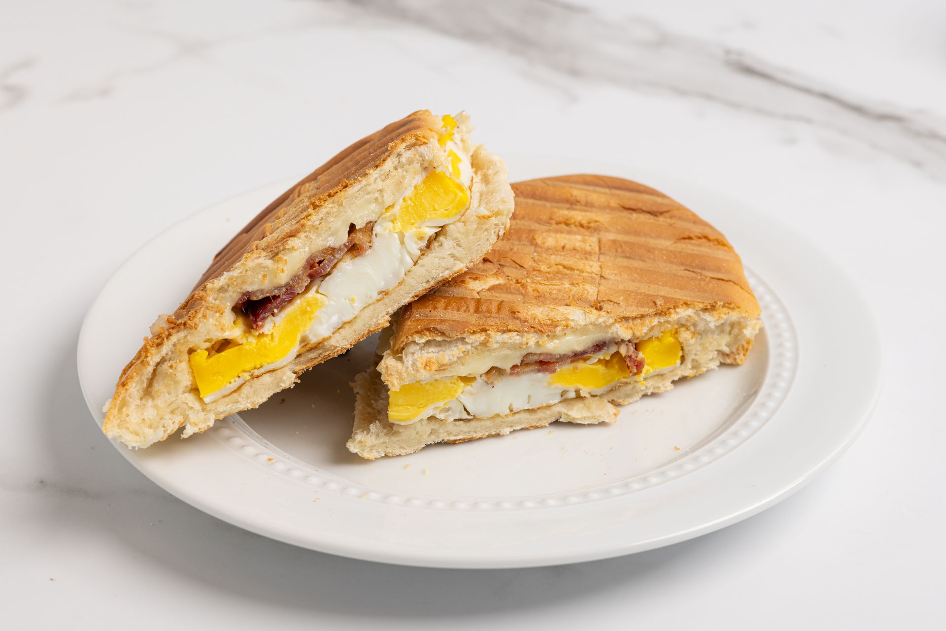 A breakfast sandwich of bacon, egg, and cheese