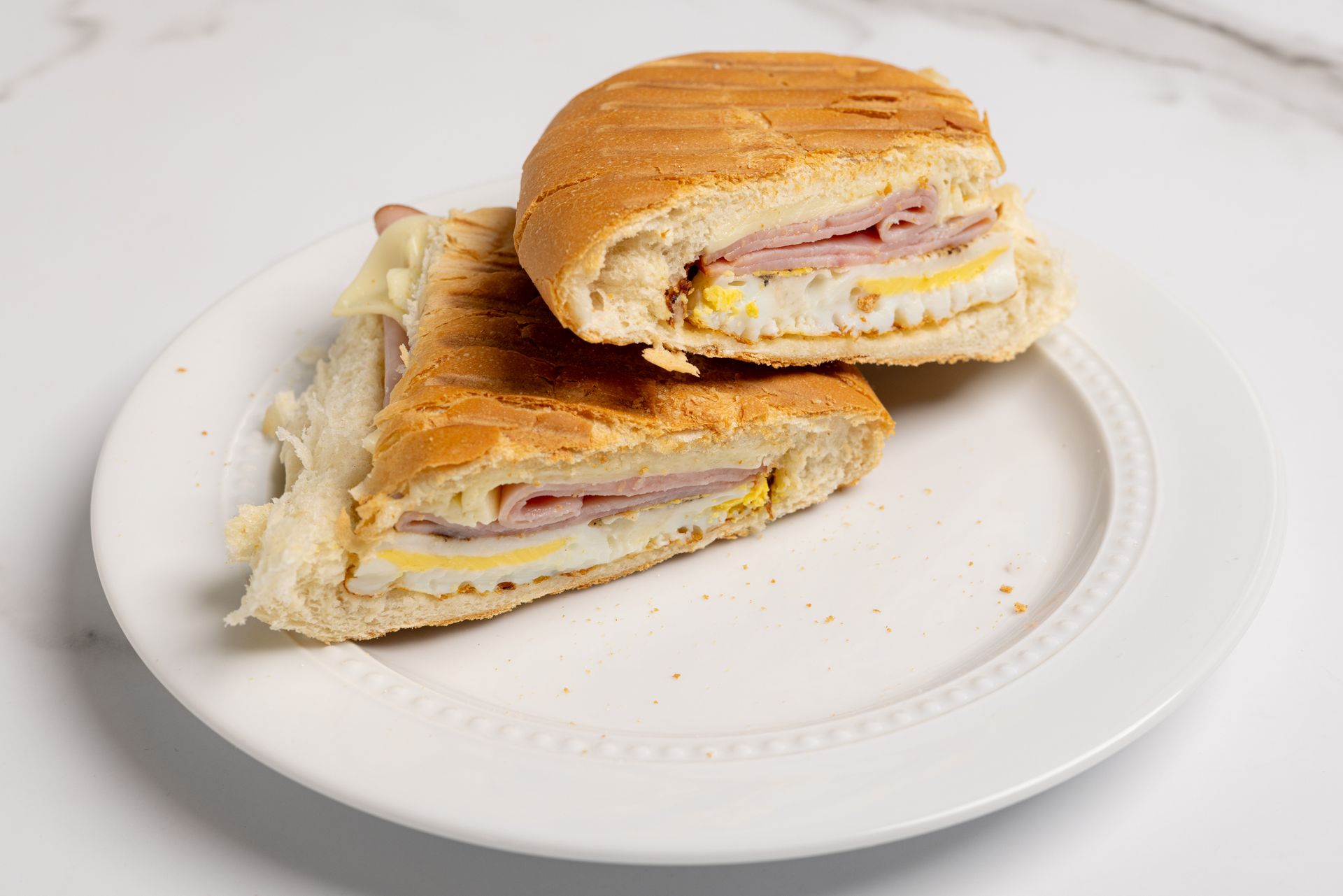 A ham, egg, and Swiss cheese panini sandwich