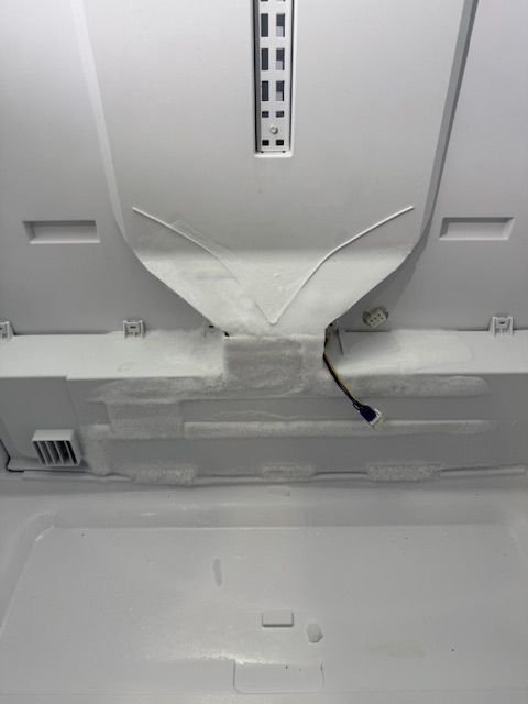 A close up of the inside of a refrigerator with the door open.