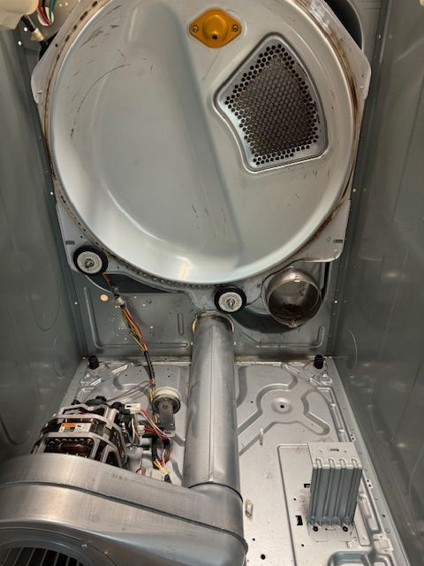 The inside of a washer and dryer with the door open.