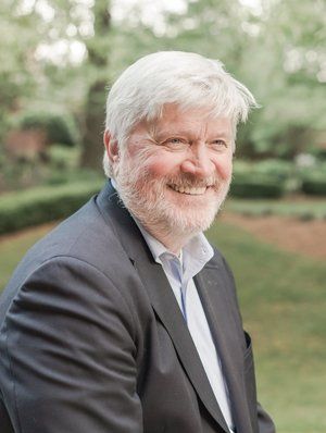 Thomas Oppel wearing a suit and smiling.