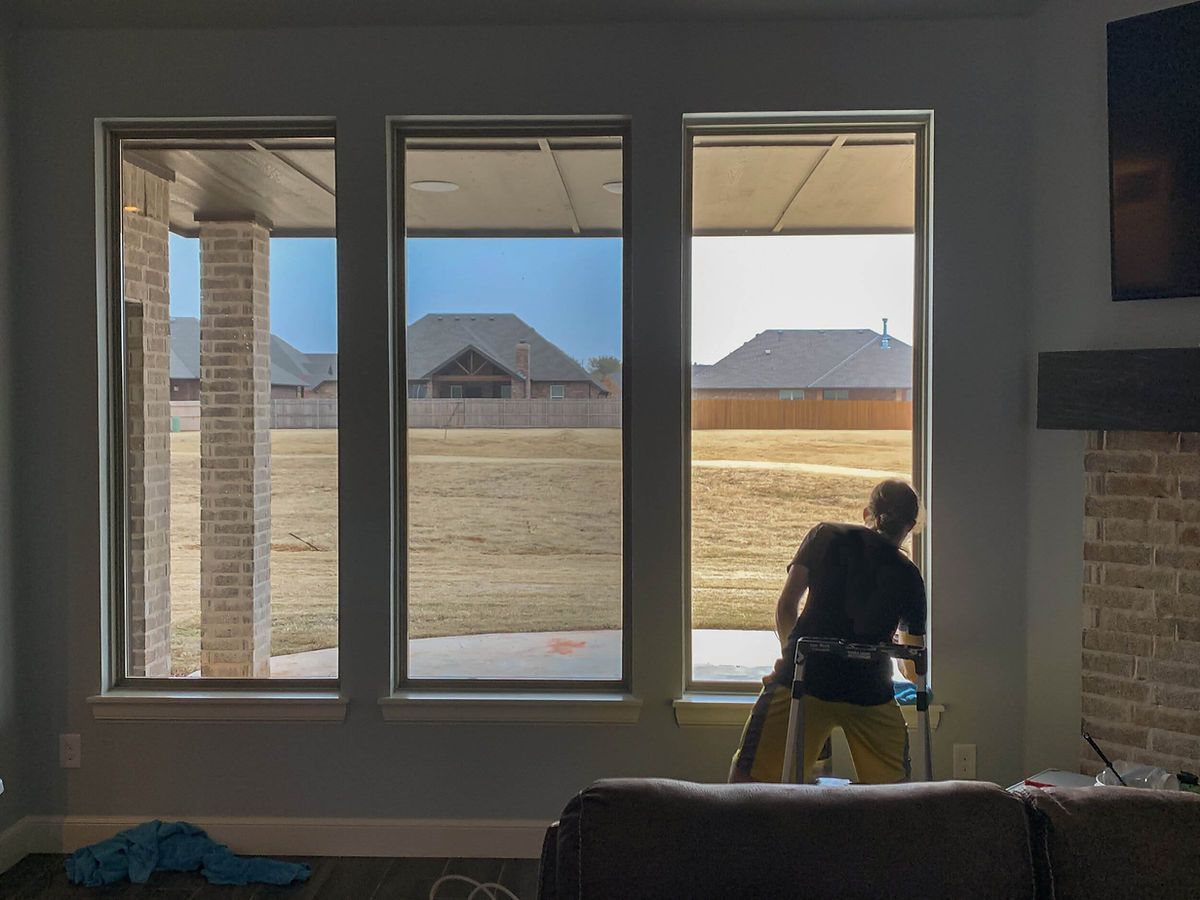 a man is cleaning a window in a living room