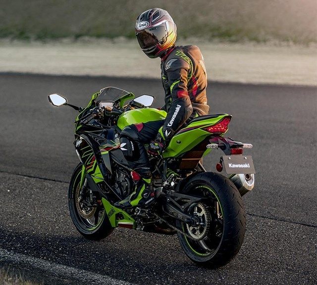 A Man is Riding a Green Motorcycle on a Road — Mackay Kawasaki in North Mackay, QLD