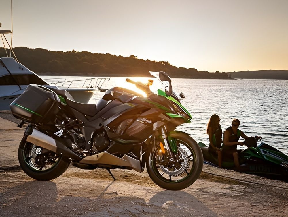 A Motorcycle is Parked on a Beach Next to a Body of Water — Mackay Kawasaki in North Mackay, QLD