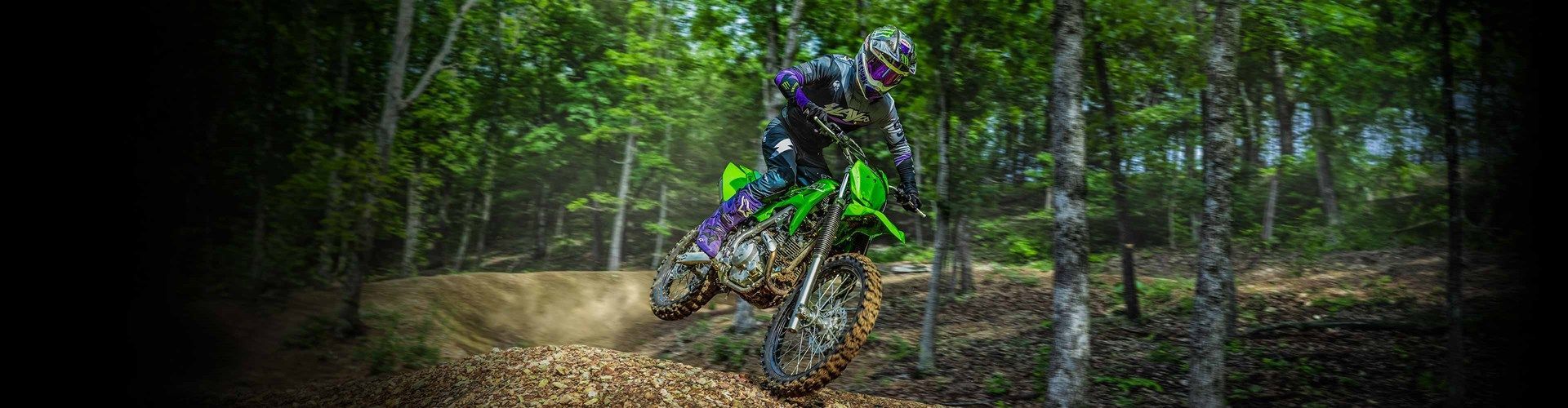 A Man Is Riding A Motorbike On A Dirt Track — Mackay Kawasaki in Mackay, QLD