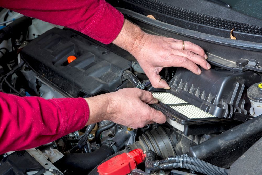 Mechanic taking out air filter