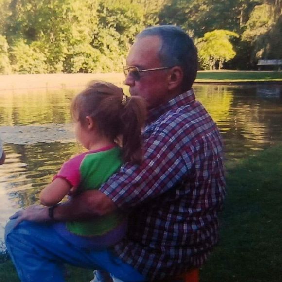 Karen Torres as a toddler and her dad enjoying a lake view together. 