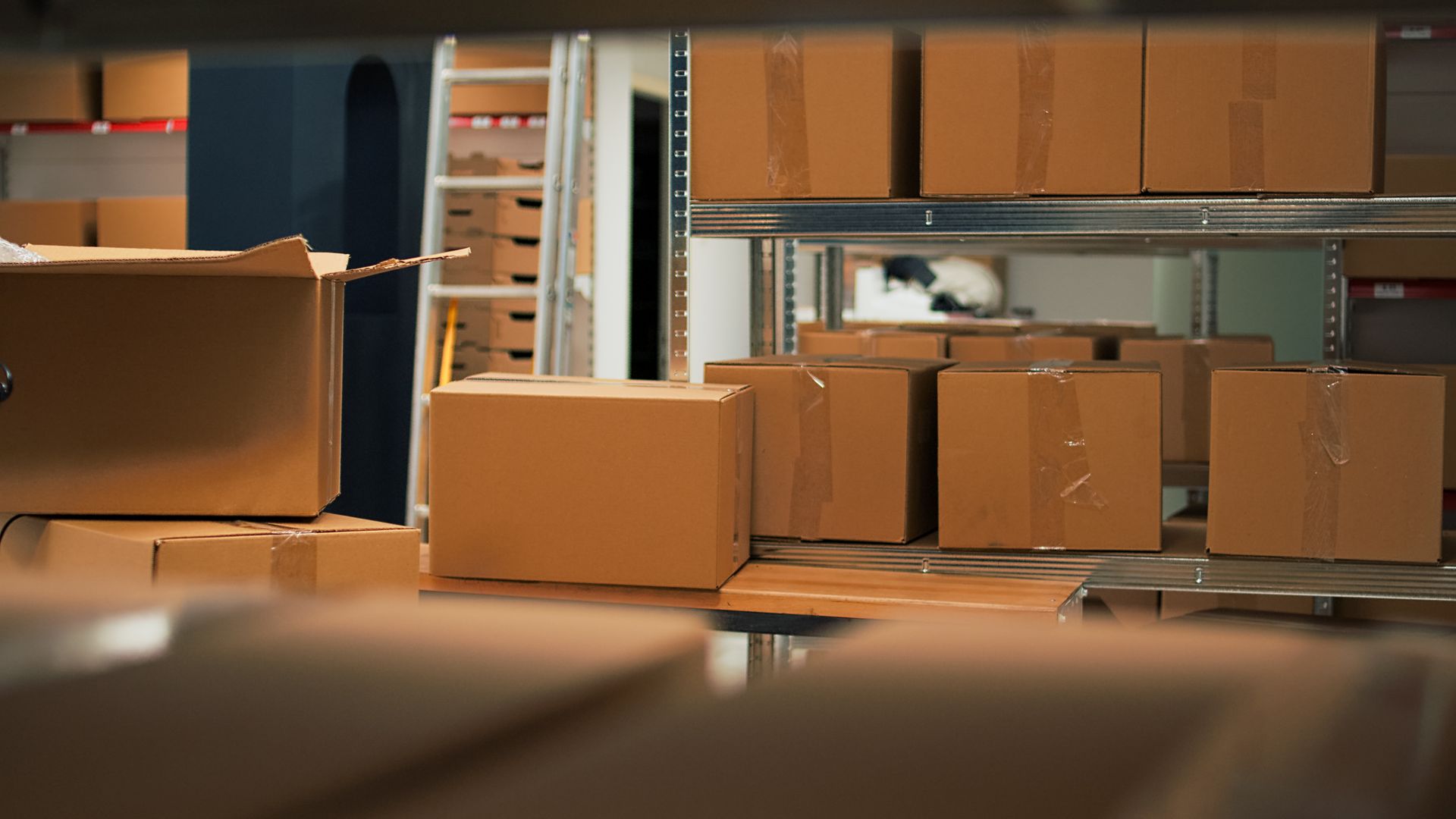 Boxes stacked on racks inside a storage unit at Edmond RV & Self Storage in Edmond, Oklahoma