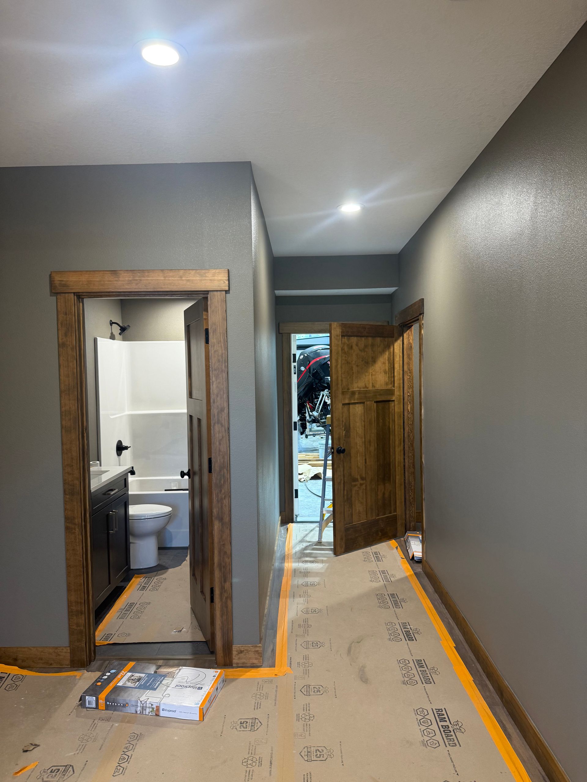 A bedroom with a bed , chair , and ceiling fan.