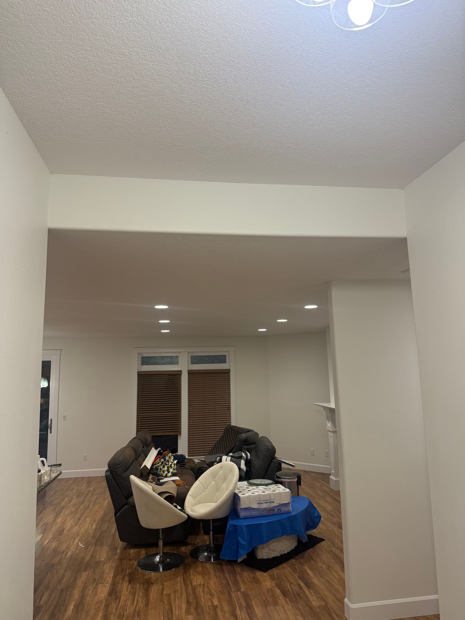 A living room with an orange couch and a rug.