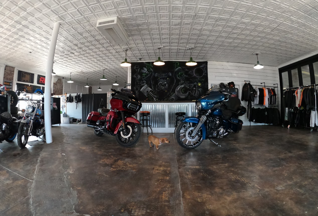 A motorcycle is sitting on top of a table in a garage.