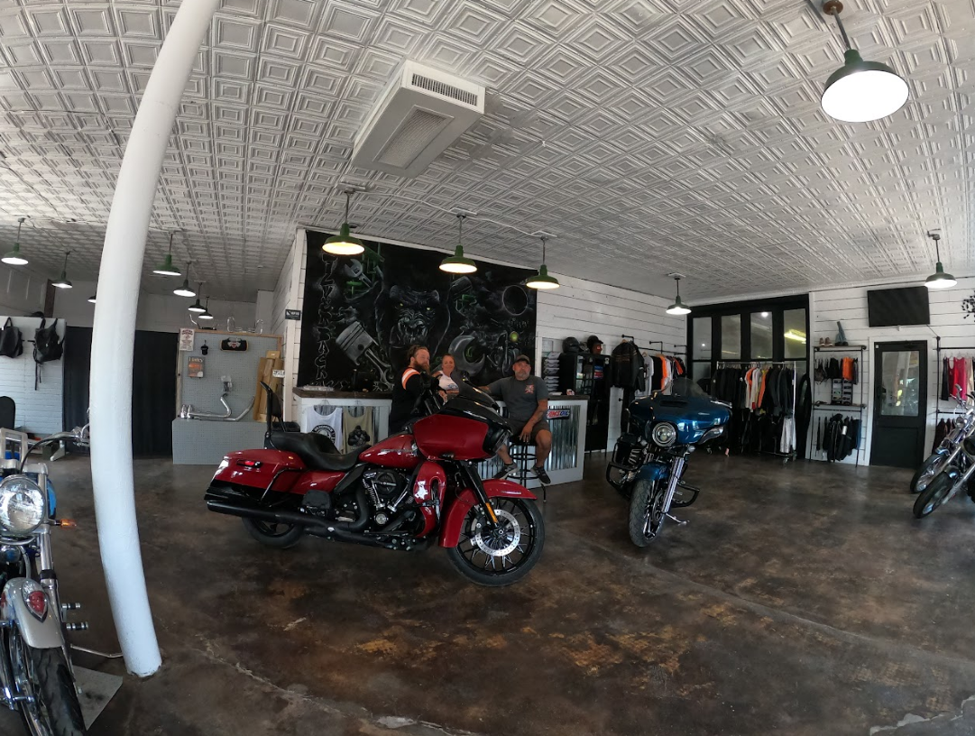 Shelves filled with motorcycle parts and a box that says headlight