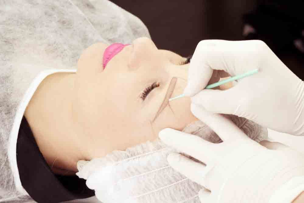 Permanent makeup being applied on lips