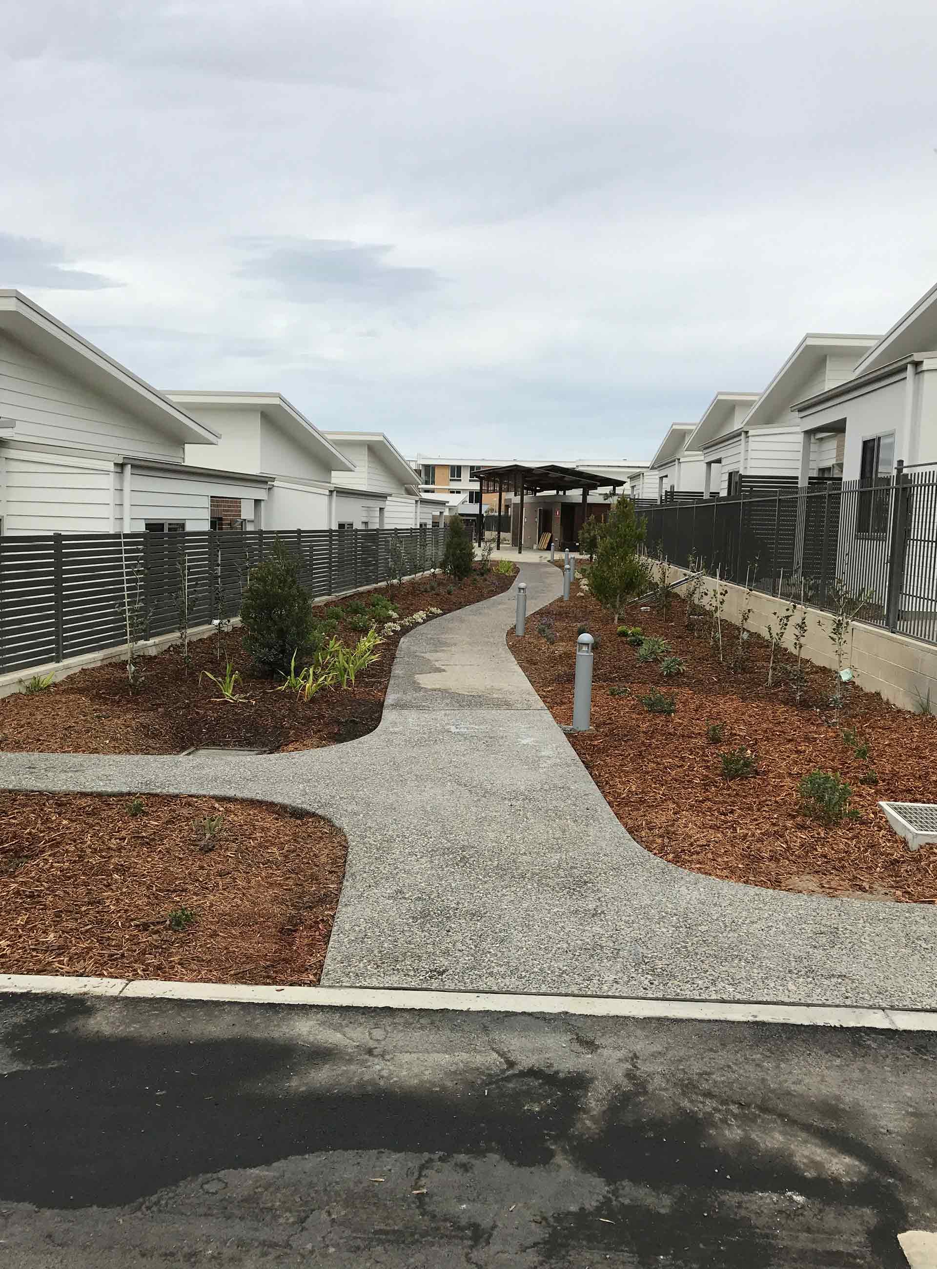 clean road to newly painted commercial houses