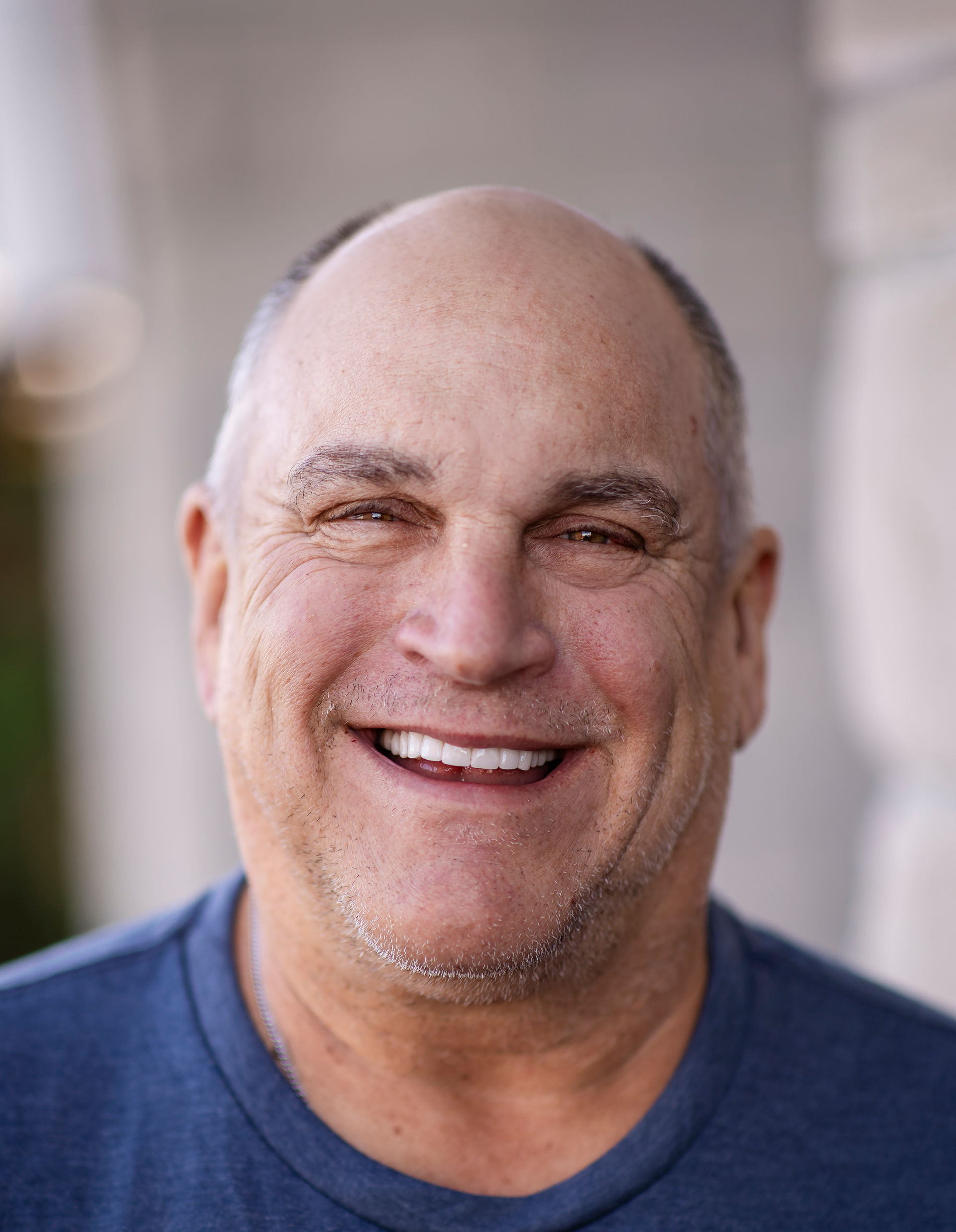 A close up of a smiling man after dental implants at Dental Arts KC