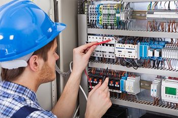 Technician Examining Fusebox — Salt Lake City, UT — Central Electric, Inc.