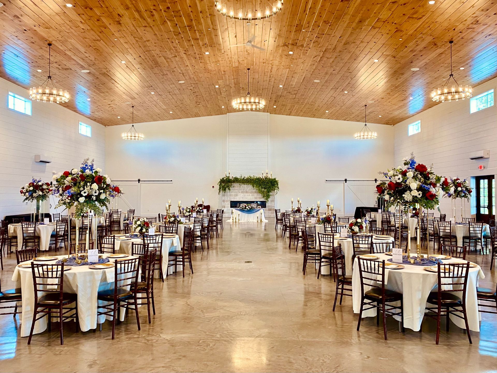 Formal place setting: pink napkin and flowers on white plates, menu, gold accents.