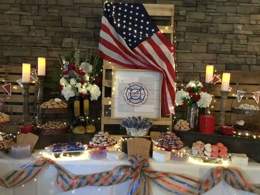 Wedding welcome display with sign, flowers, and barrel on a porch.