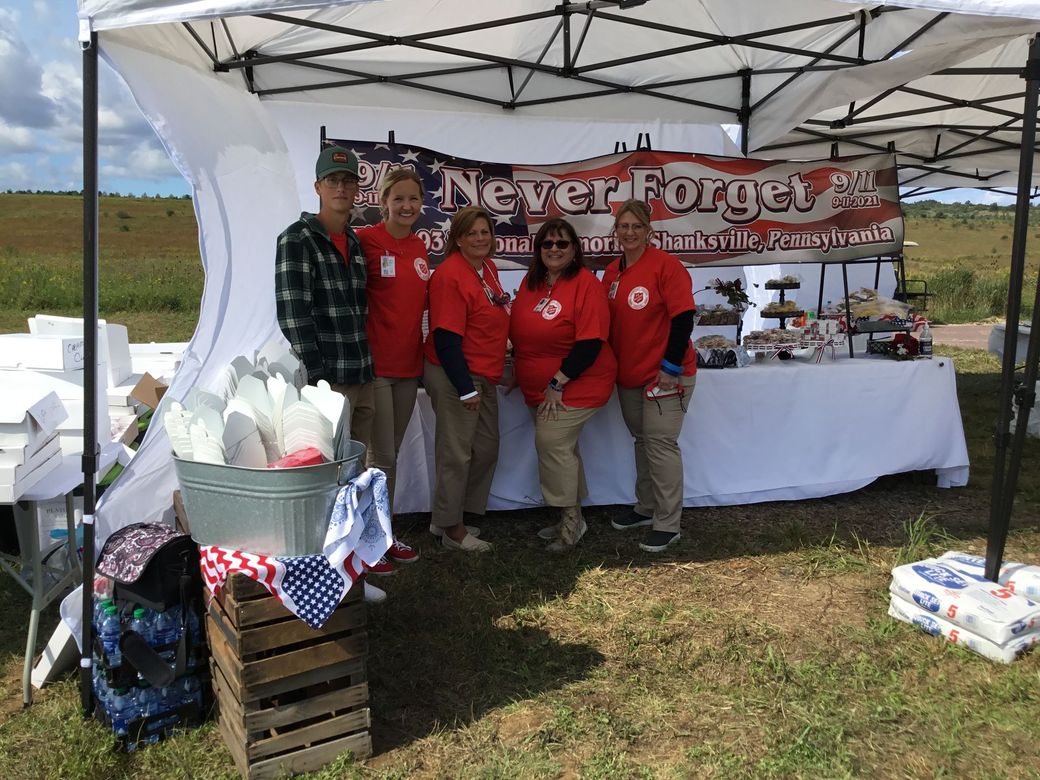 Five people stand under a 