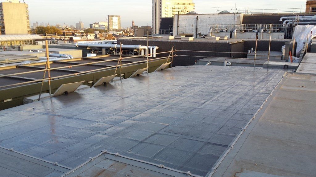 A rooftop with a lot of buildings in the background