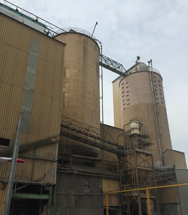 A factory with a lot of silos and stairs