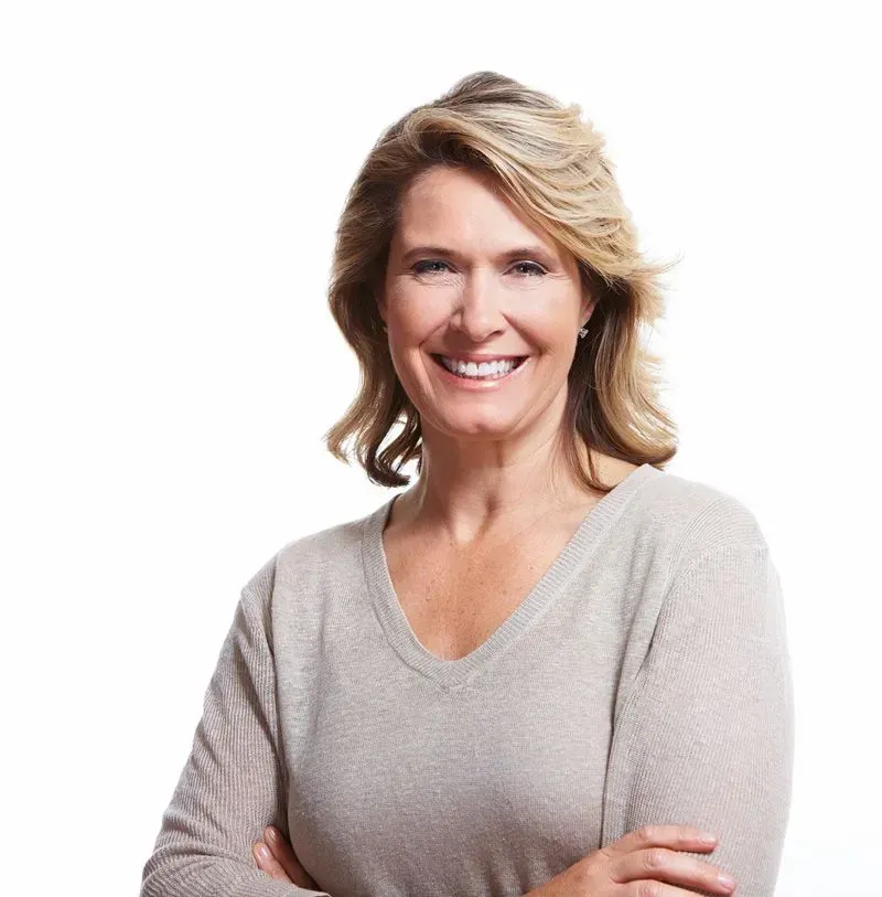 Smiling Woman With Blonde Hair Wearing a Beige Sweater — Smiles on Hudson In Lake Macquarie, NSW