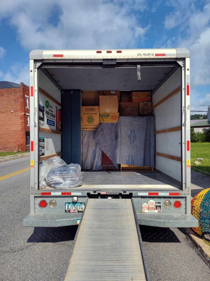 The back of a moving truck with boxes in it