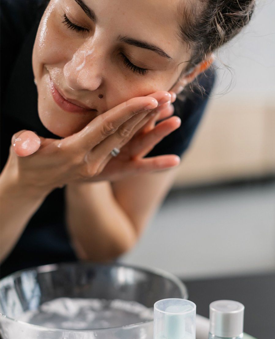 Woman putting water on face