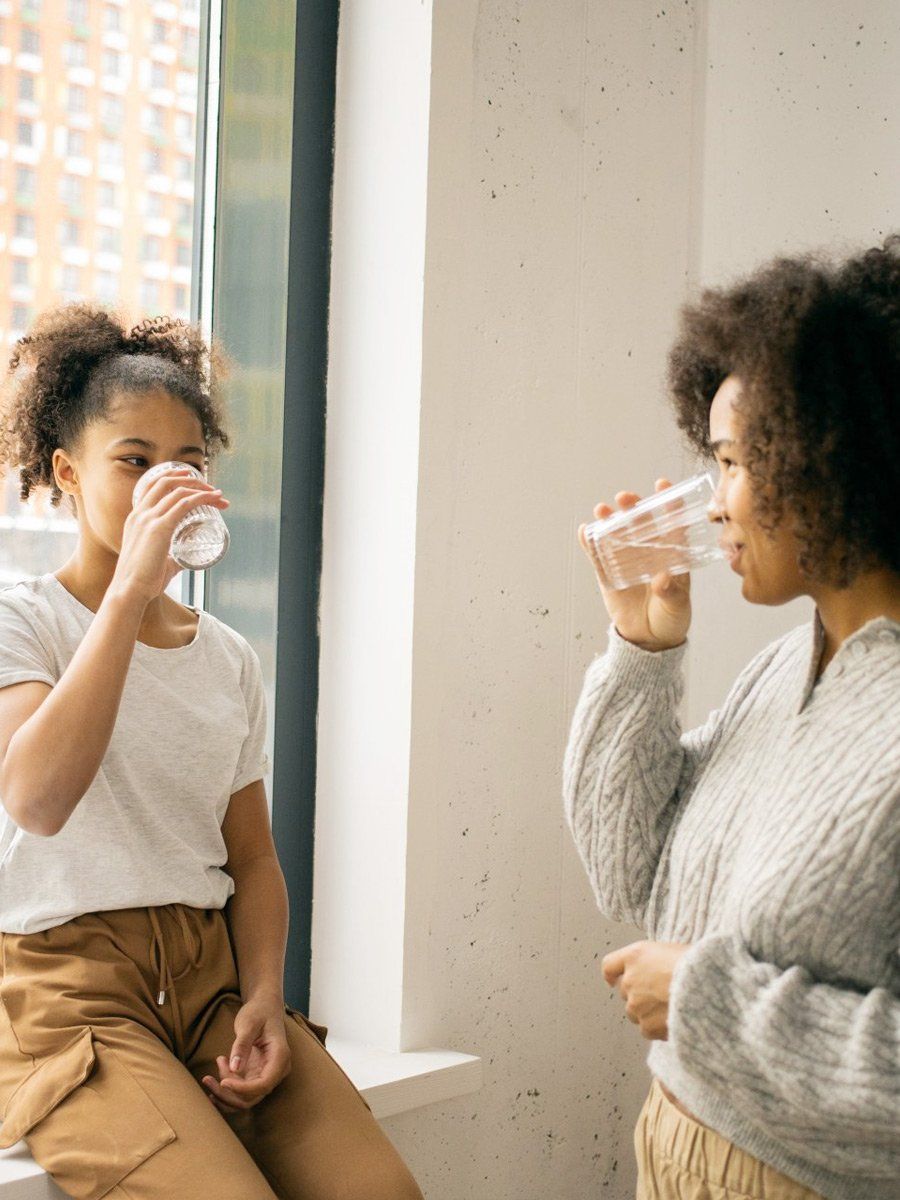 mother daughter drinking clean water