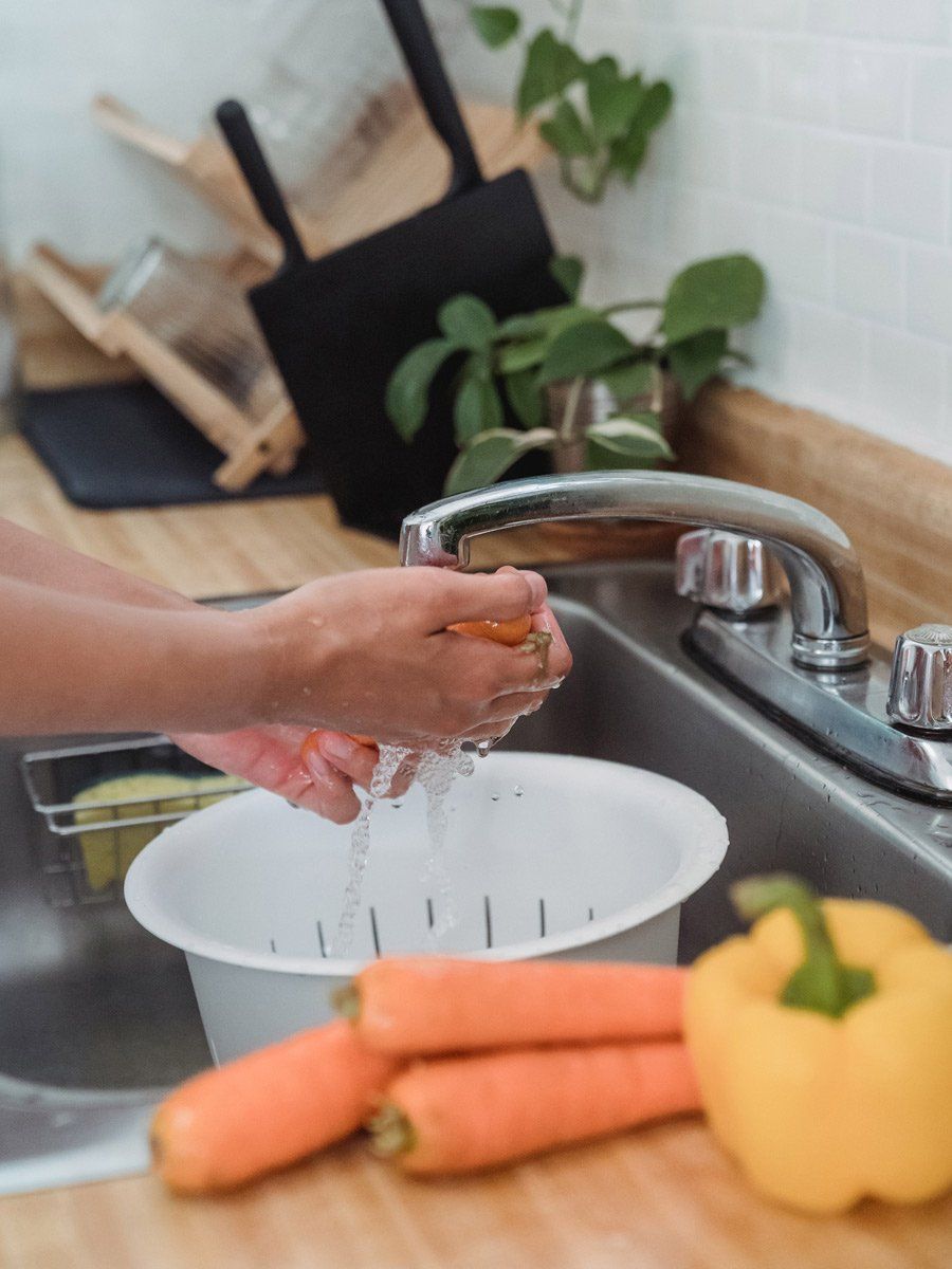 washing vegetables in the sink