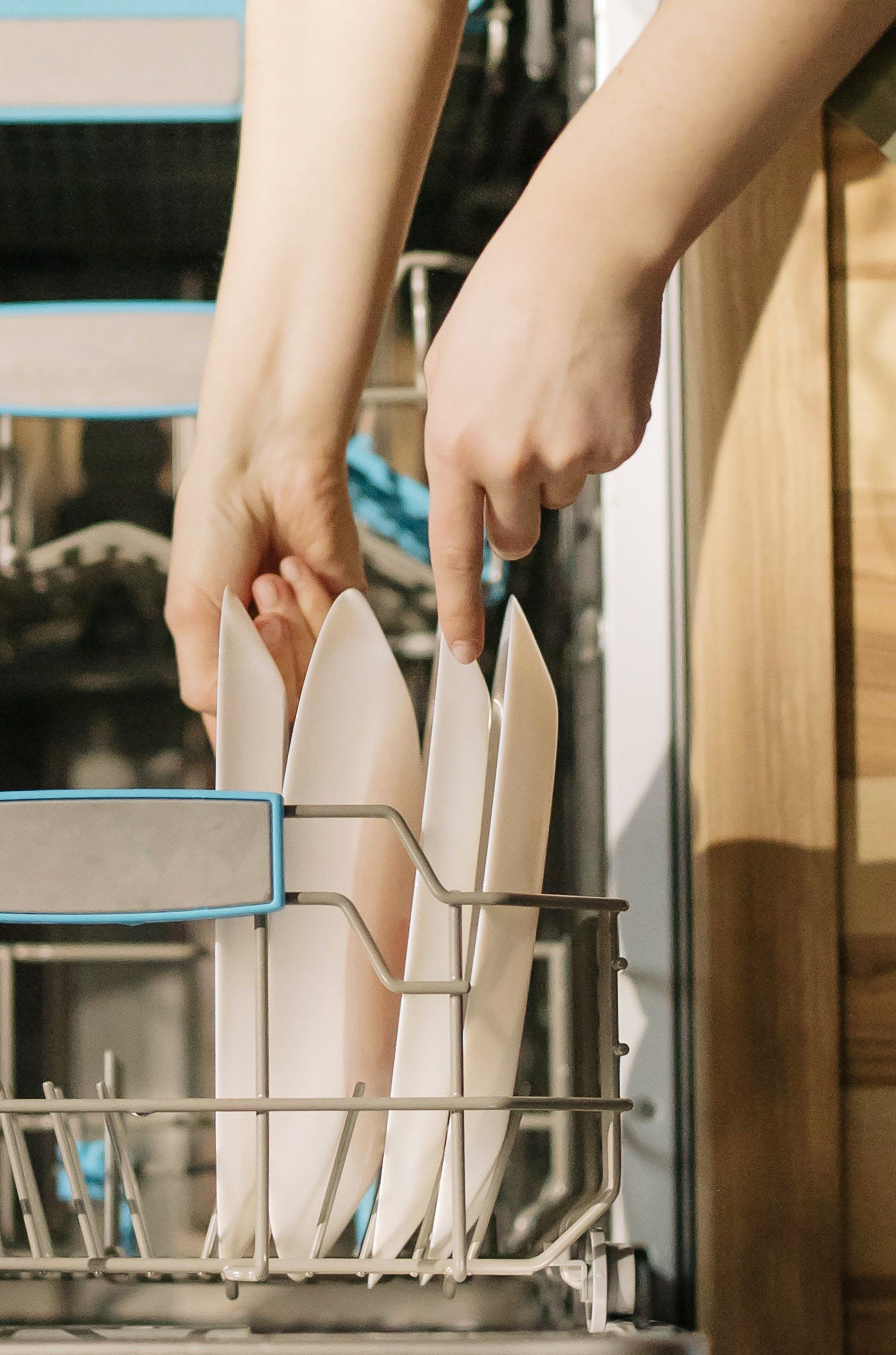 woman putting dishes in a dishwasher