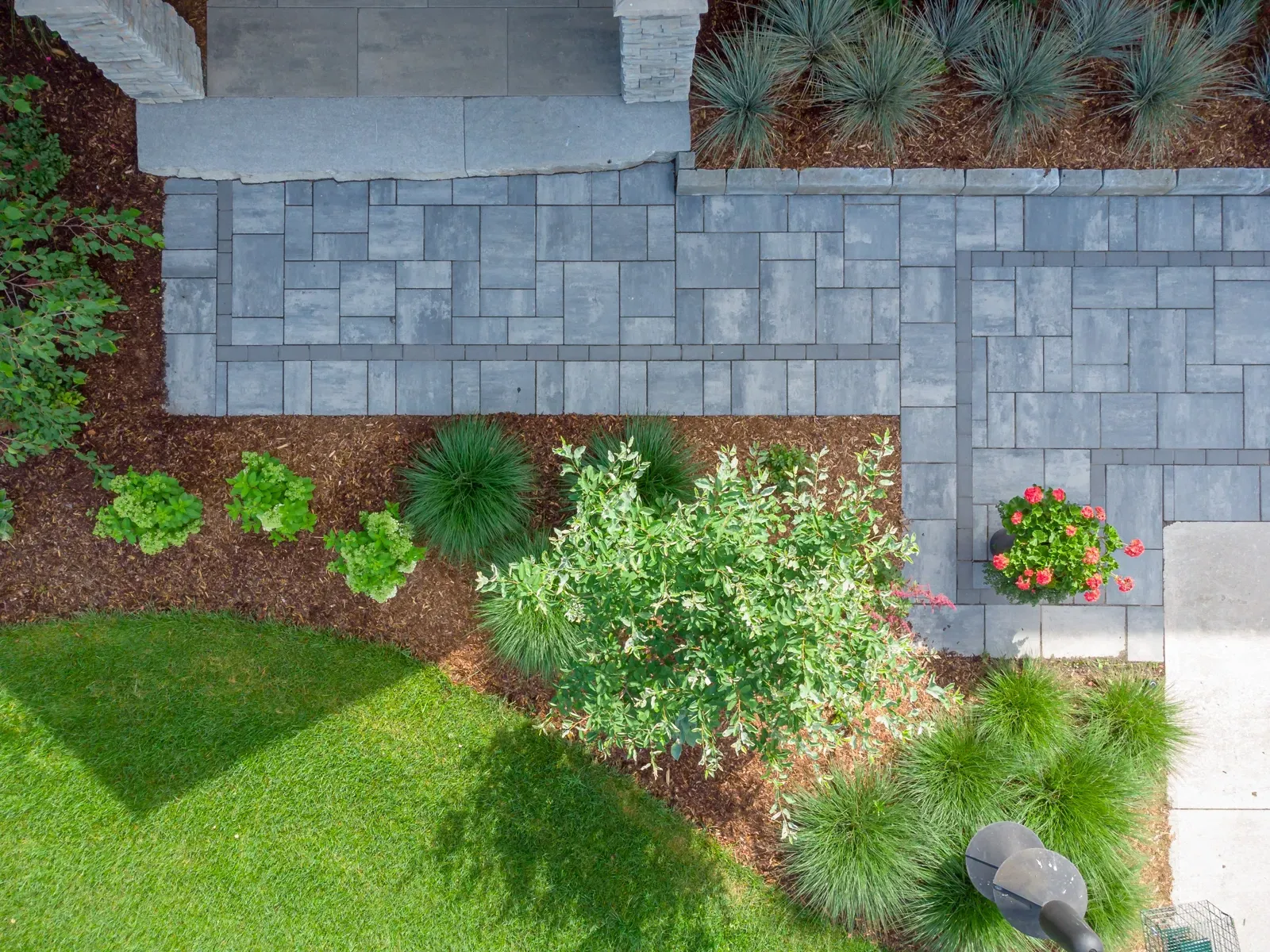 An aerial view of a brick walkway leading to a house.