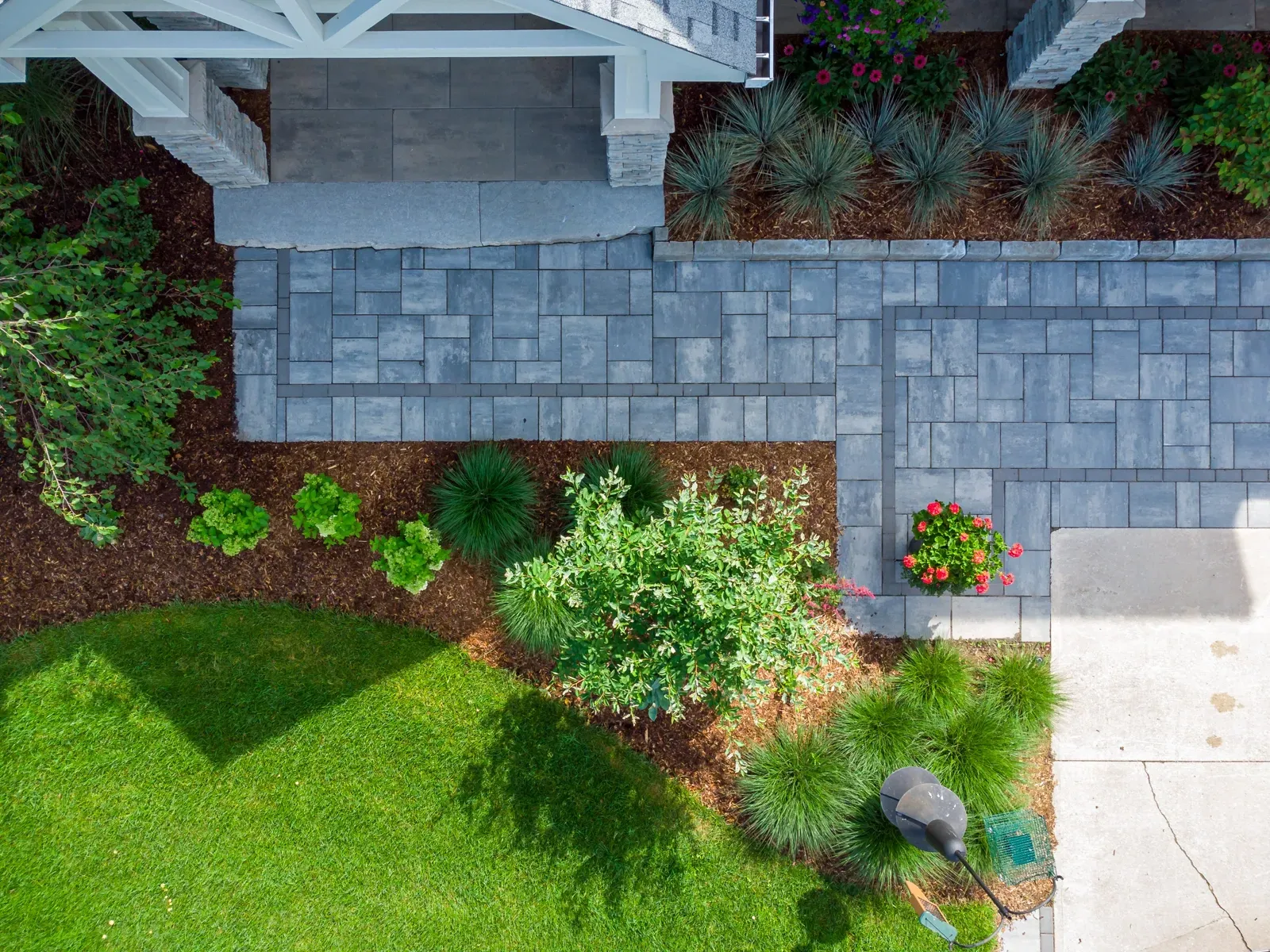 An aerial view of a brick walkway leading to a house.