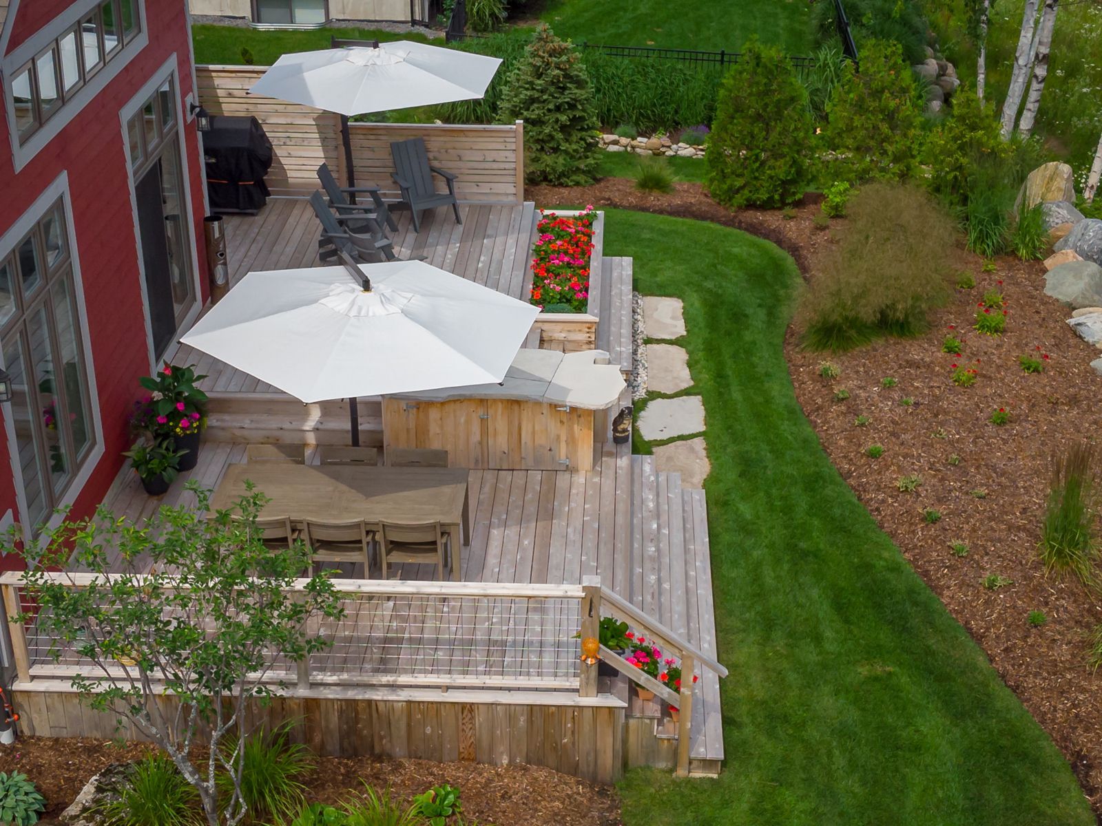 An aerial view of a deck with umbrellas and a table