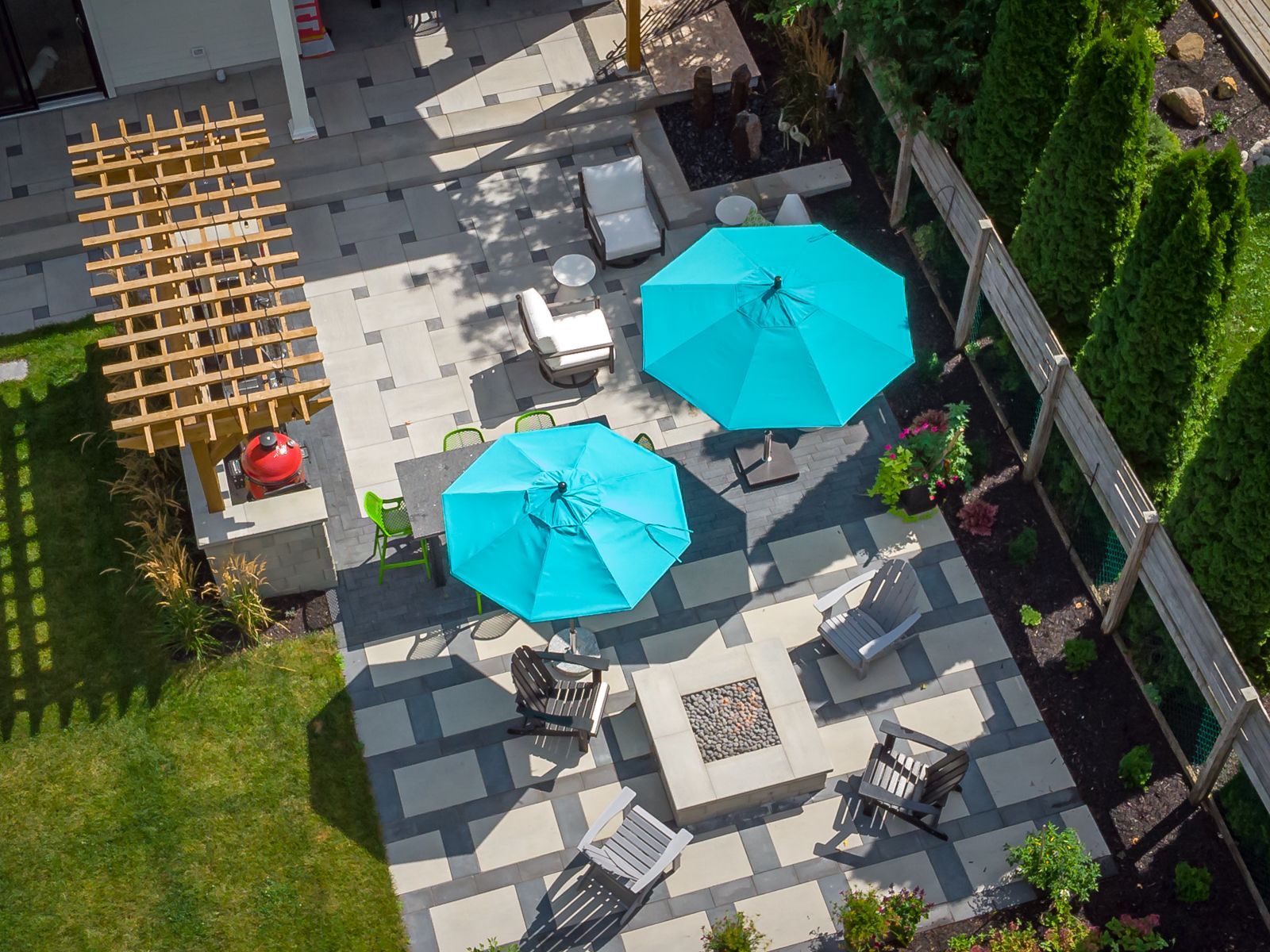 An aerial view of a patio with blue umbrellas and chairs.