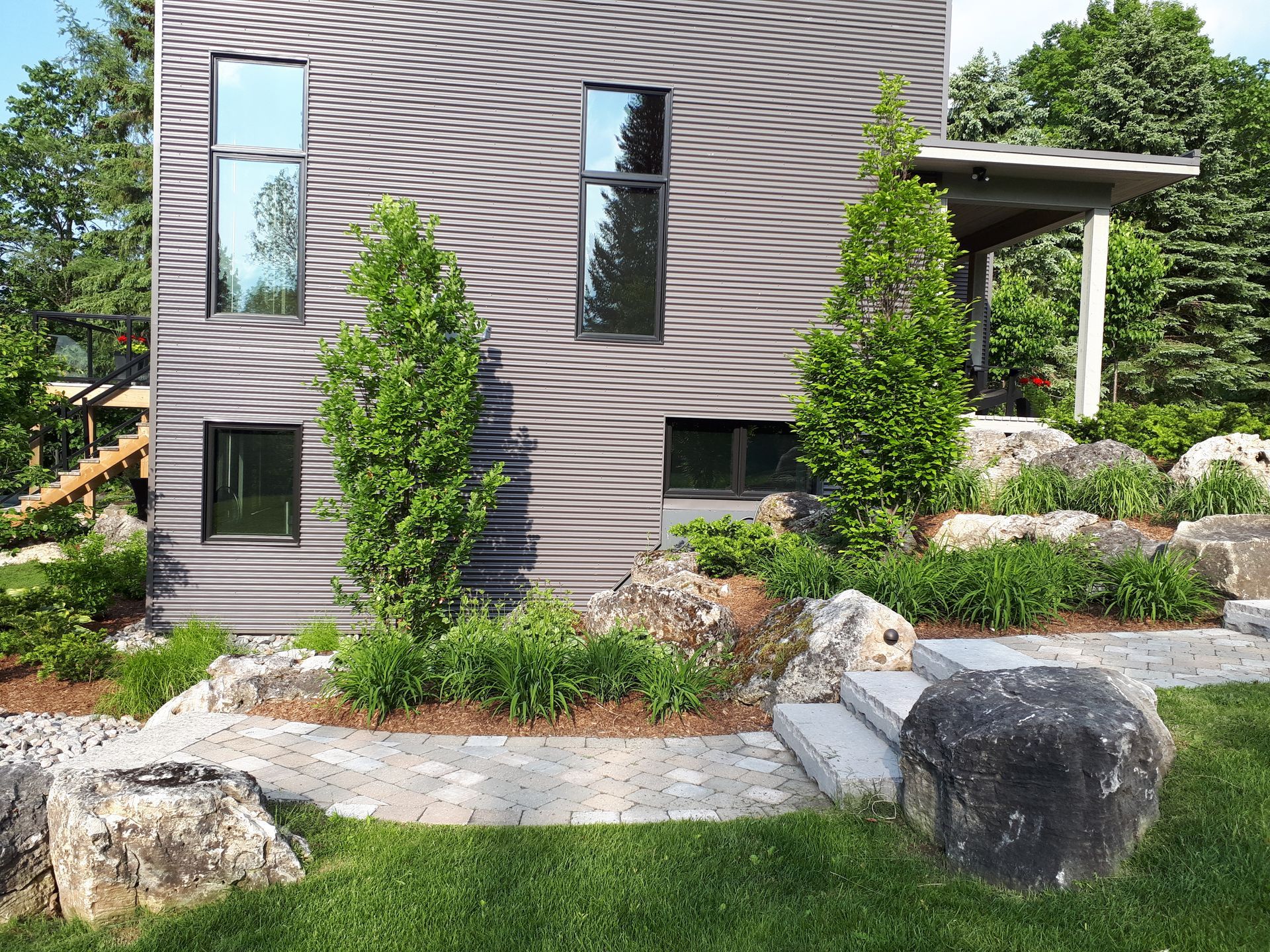 A house with a lot of windows and trees in front of it