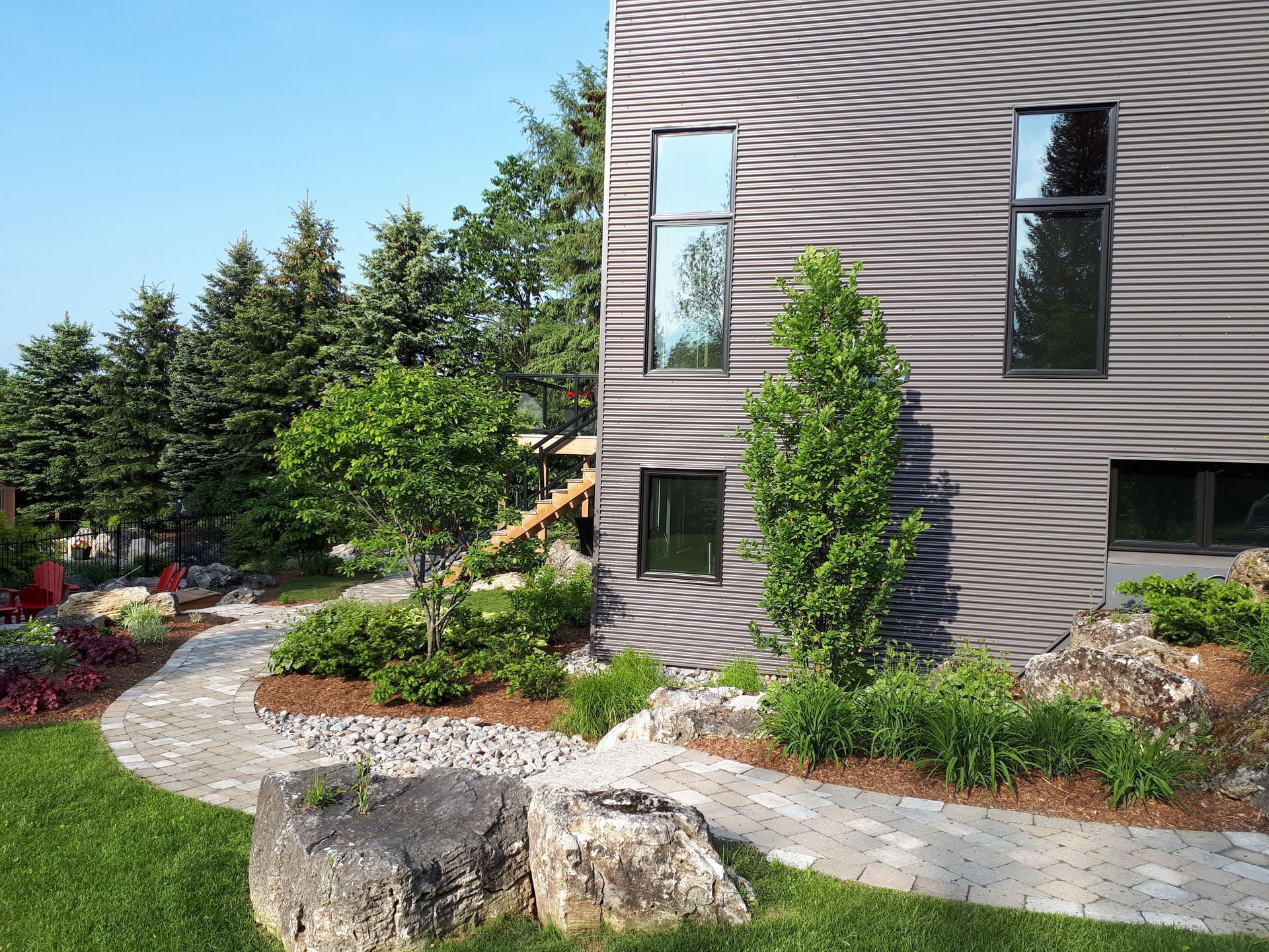 A house with a lot of windows and trees in front of it