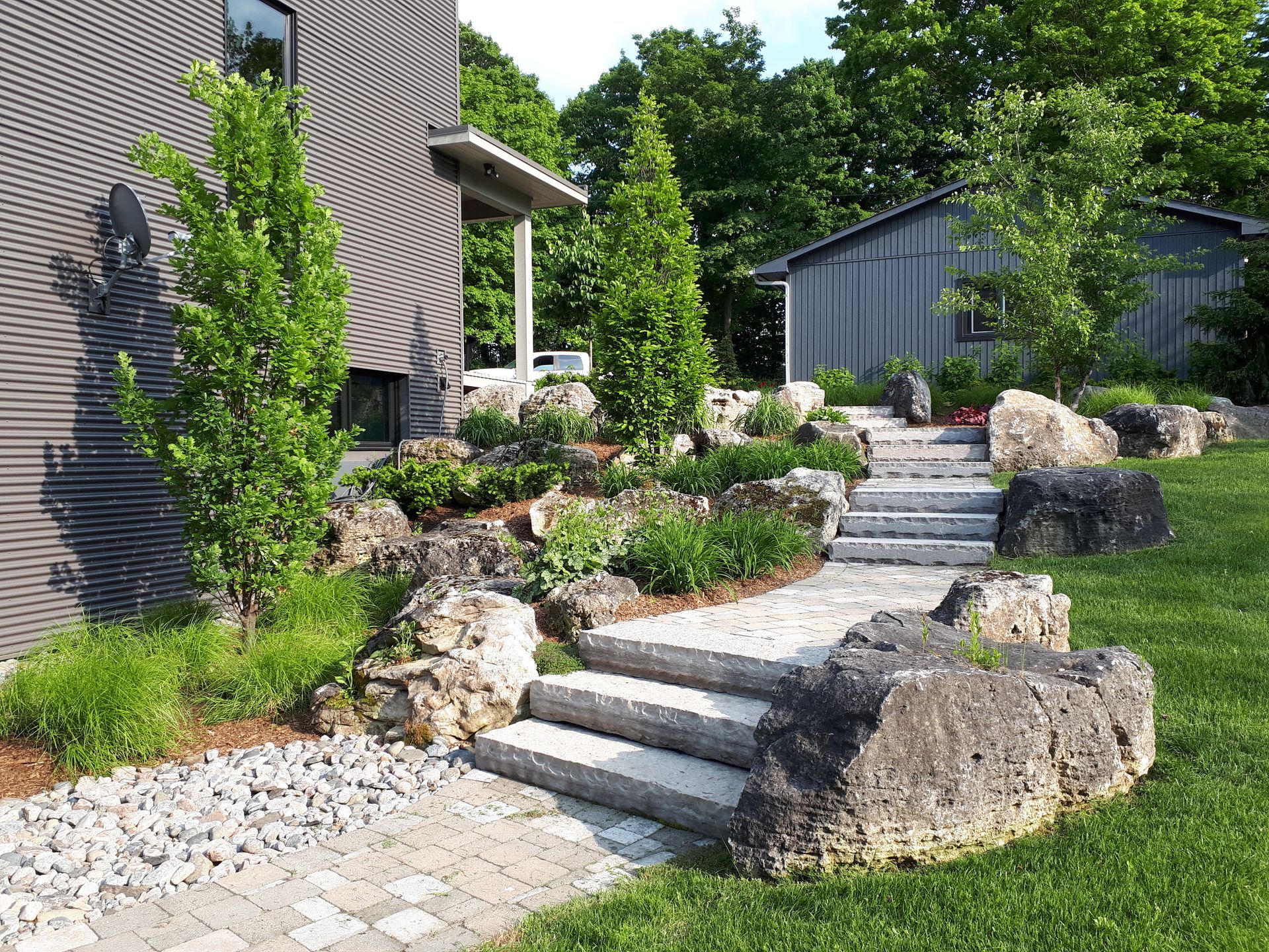 There are stairs leading up to a house in the backyard.