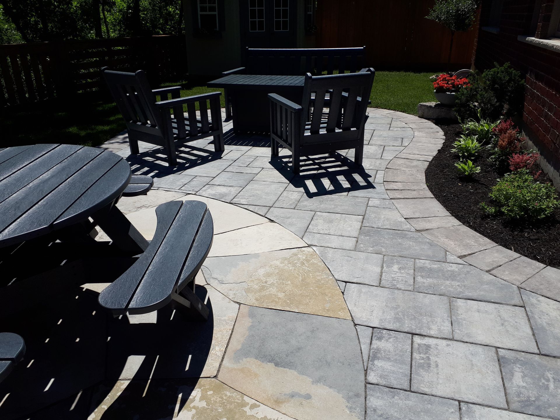 A patio with a table and chairs on it