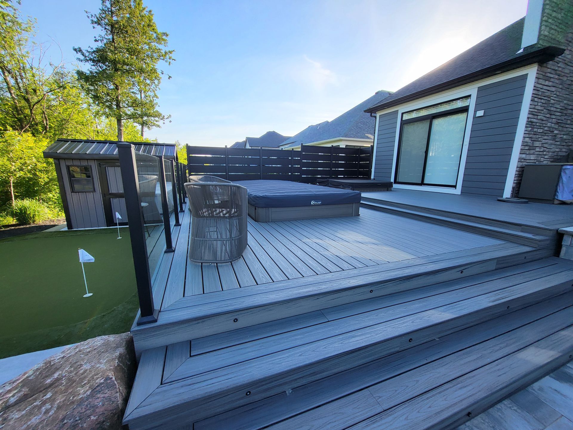 There is a hot tub on the deck of a house.