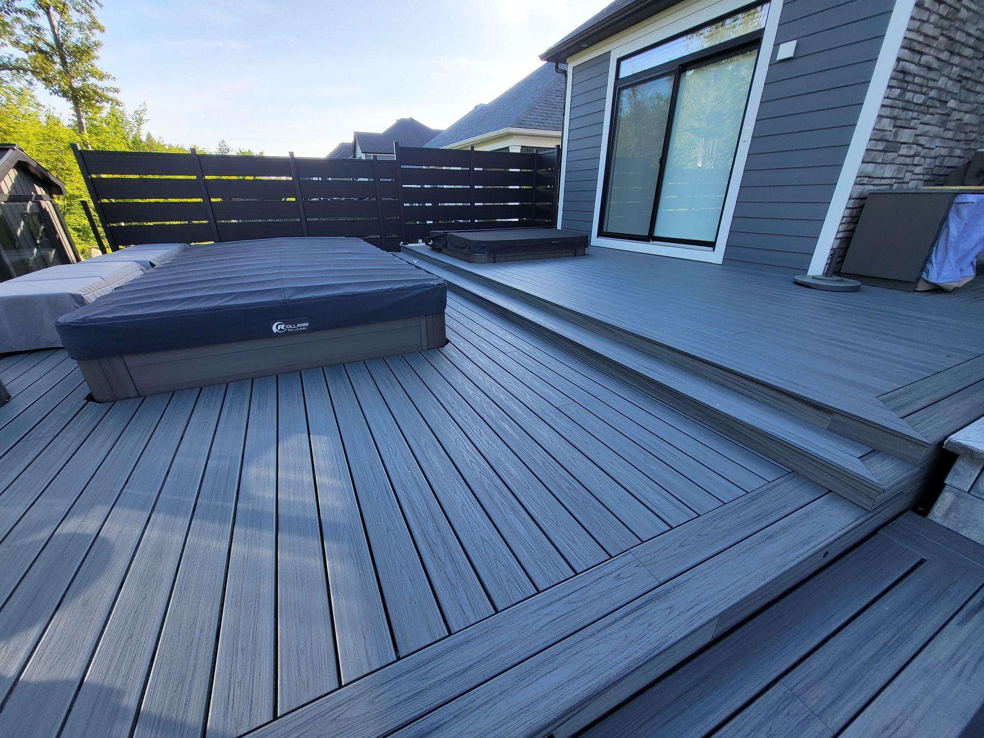 There is a hot tub on the deck of a house.