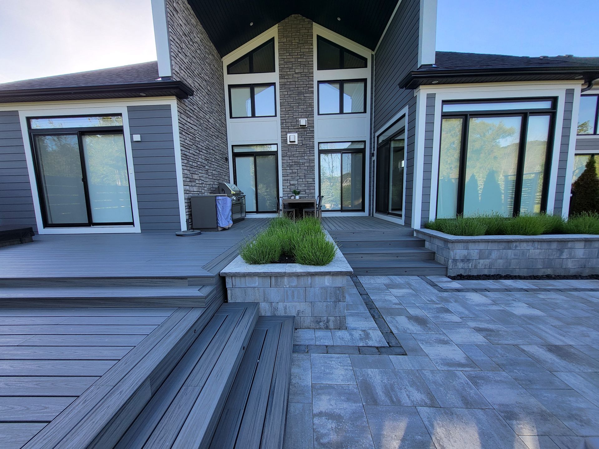 A large house with a patio and stairs in front of it.