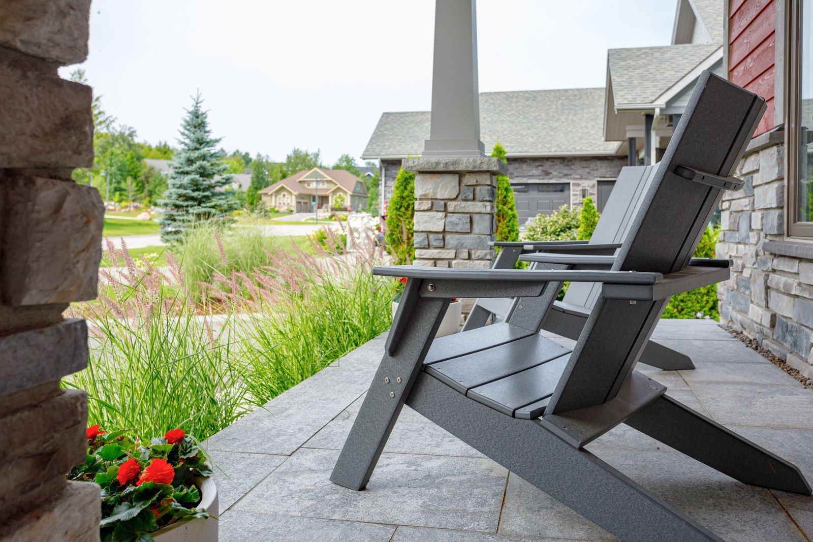 A chair is sitting on a porch in front of a house.