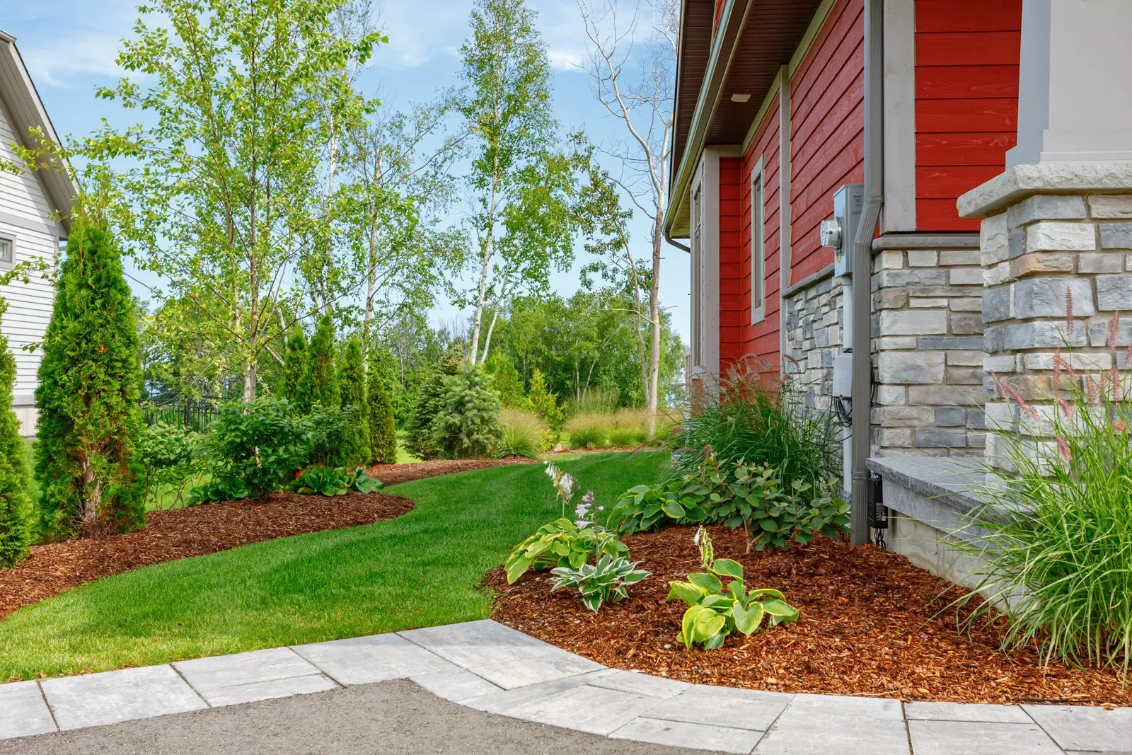 There is a walkway leading to the front of the house.