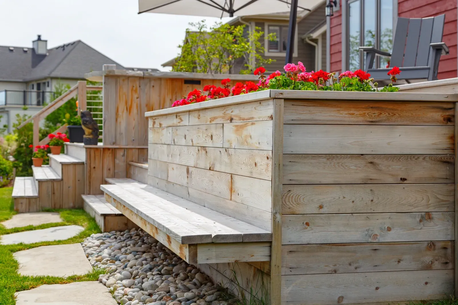 A wooden bench is sitting on top of a wooden planter.